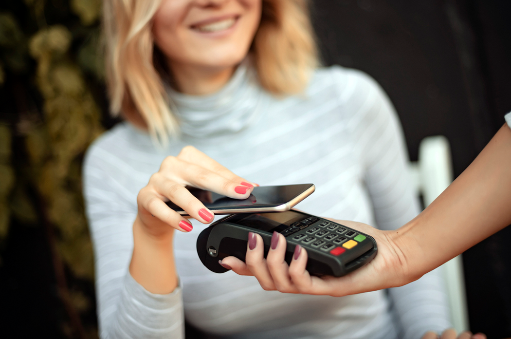 woman paying using digital wallet on her smartphone