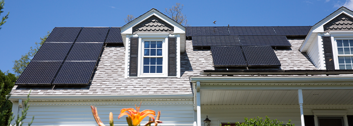 Roof of a home with black solar panels on it