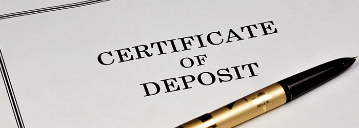 Document that says Certificate of Deposit with a pen lying on top of it